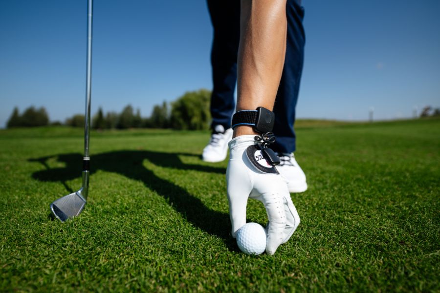 Placing Down Golf Ball on The Grass