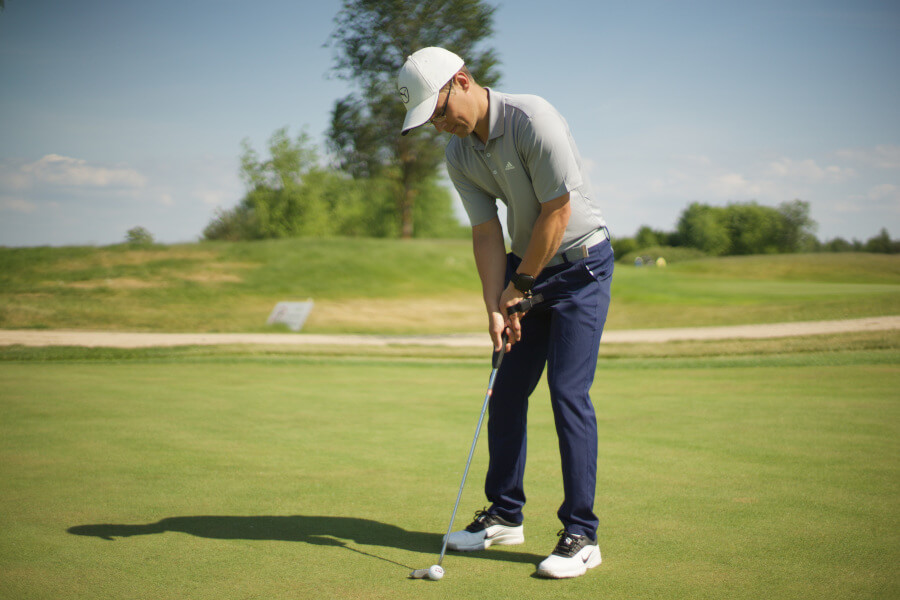 golf player putting with iron