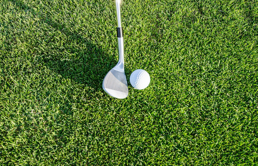 golf wedge and golf ball on course