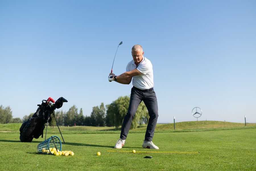 golfer training using hackmotion and alignment sticks on ground